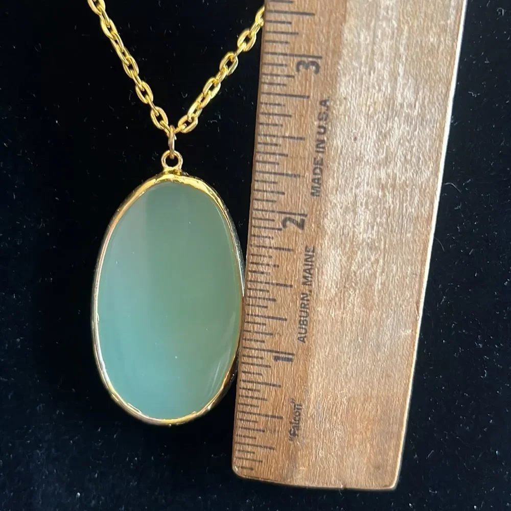 Handcrafted green glass pendant on 24 inch gold tone chain